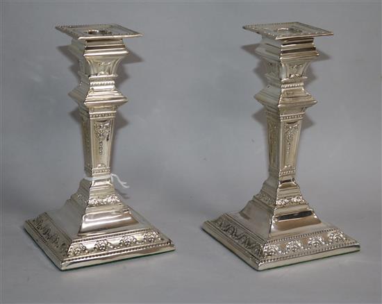 A pair of late Victorian repousse silver candlesticks, by Charles Stuart Harris, London, 1896, weighted.